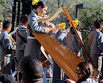 Mariachi Mestizo performing at park event with harp..